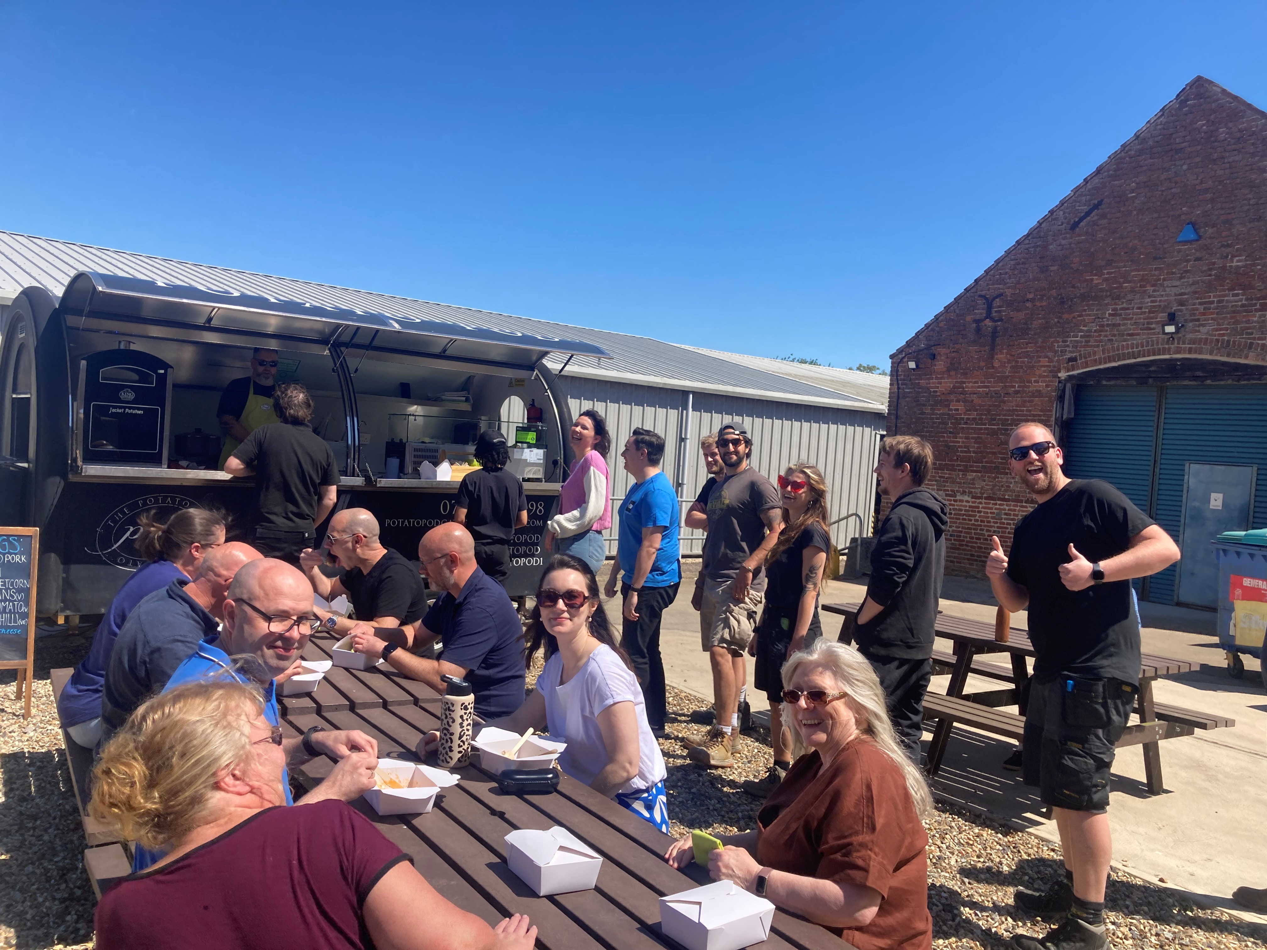production bureau staff enjoying hot lunch from locak jacket potato food van