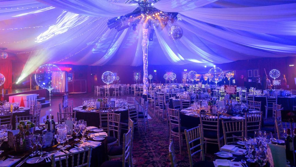 live events tent with multiple lights and tables set up